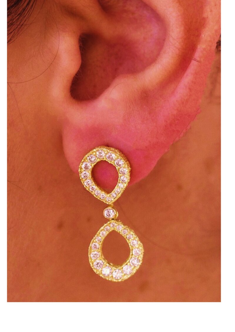diamond infinity earrings on model