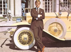 The Great Gatsby stands in front of a Rolls Royce